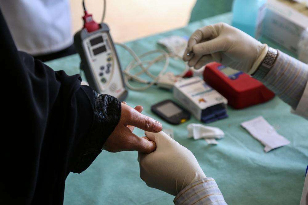 A nurse checks on an elderly diabetic patient at an MSF-run health center in Al Bab, Syria.