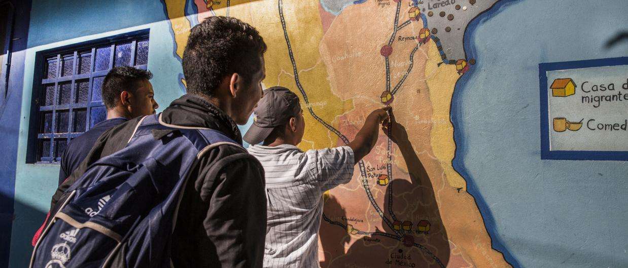 Men check a map at the La 72 migrant shelter in Tenosique, Mexico.