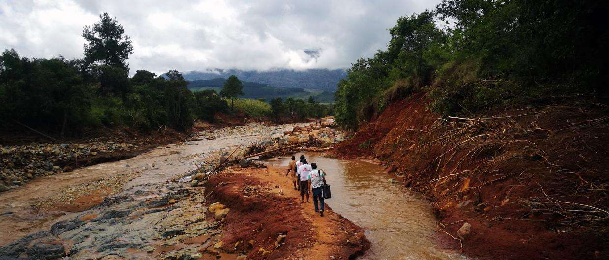 An MSF mobile team walks to access a village cut off by damage caused by Cylone Idai in Chimanimani, Zimbabwe.