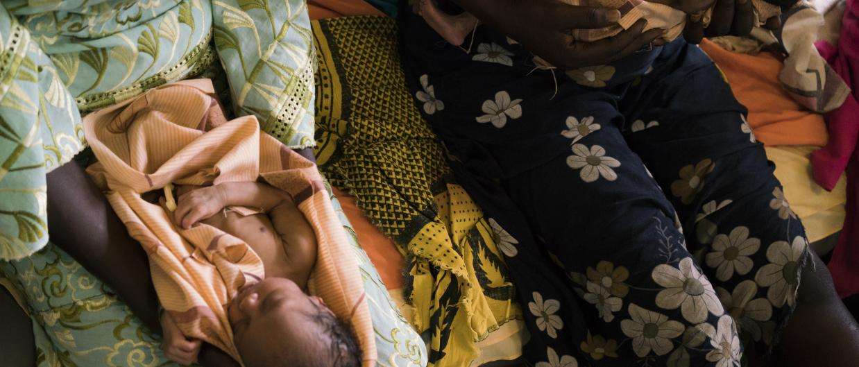 Twins are held on the bed in the maternity ward of the MSF hospital in Aweil, South Sudan.  