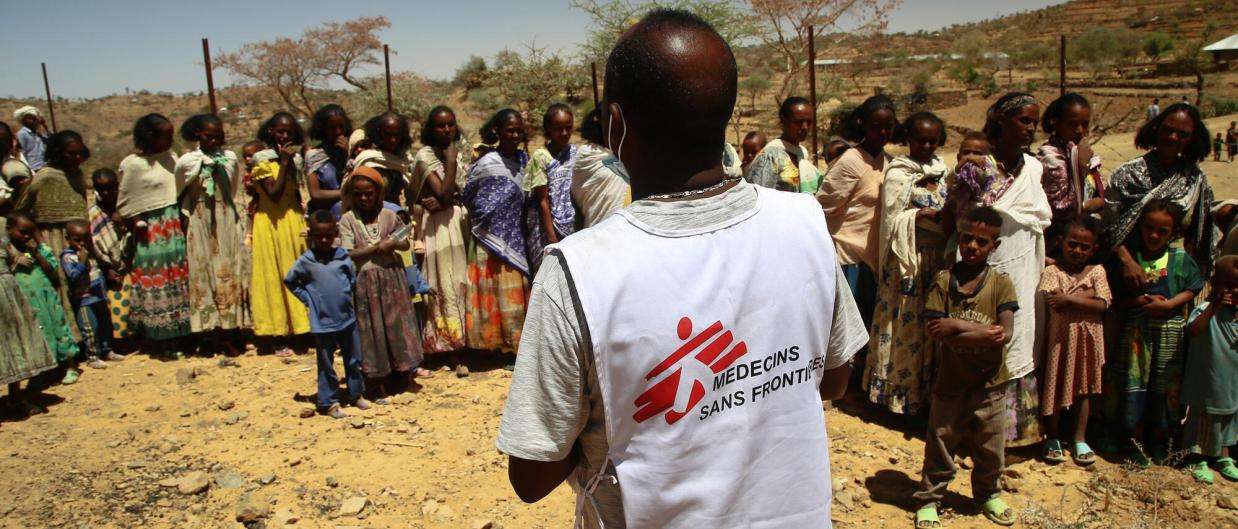 An MSF translator provides information to women and children waiting for a medical consultation at a mobile clinic in the village of Adiftaw, Tigray.