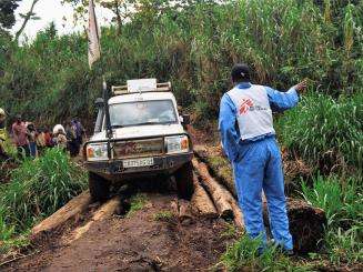 A driver with MSF directs a car over a log-bridge on the road from Nyabiondo towards the village of Kazinga in Masisi territory, in the east of the Democratic Republic of the Congo.