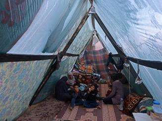 Displaced Palestinians inside a tent in Rafah, Gaza.
