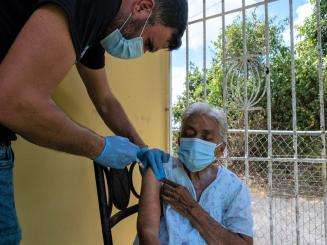 Rolando Betancourt of Puerto Rico Salud vaccinates a resident of Humacao on the eastern coast of Puerto Rico.