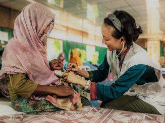 MSF fieldworker providing care to a child in the MSF hospital in Goyalmara.