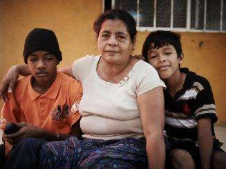 Pictured here in Mexico, 54-year-old Rosa fled gang violence in El Salvador with two of her grandchildren.