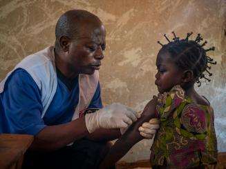 A young girl receives a measles vaccination