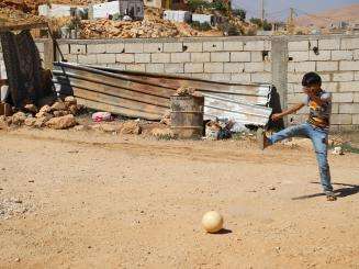 A child kicking a ball in Lebanon