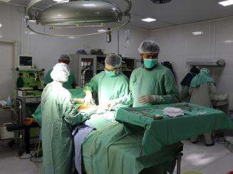 A medical team prepares to begin a surgery in the operating theater of Boost hospital, Lashkar Gah, Afghanistan.