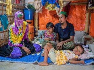 A Rohingya refugee family inside their shelter.