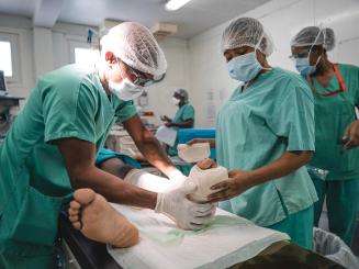 MSF medical staff treat a patient on an operating table at Tabarre hospital in Port-au-Prince, Haiti.