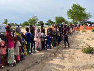 Line of Sudanese refugees outside waiting for MSF vaccines in Central African Republic