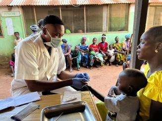 An MSF staff member tests a young child for malaria in Batangafo, Central African Republic.