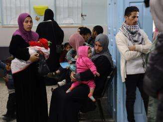 Patients wait for care inside the Al-Shaboura clinic in Rafah, Gaza.
