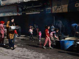 Displaced Palestinian children cook in the southern Gaza town of Rafah’s Al-Shaboura neighborhood.