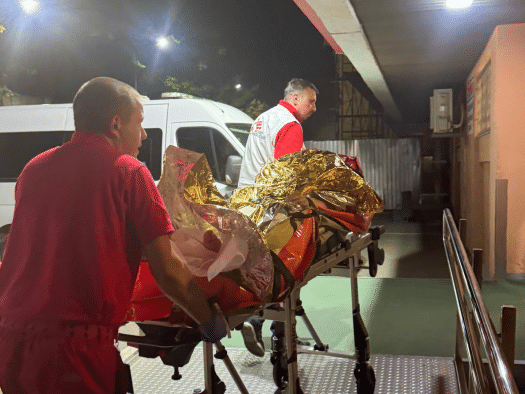 MSF teams transport a patient on a stretcher after a Russian attack on Ukraine.