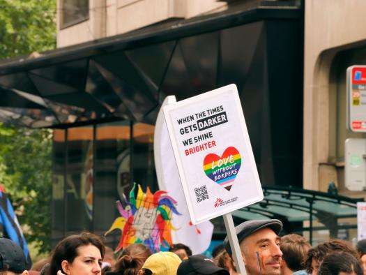 MSF staff hold a Love Without Borders sign at a Pride march in Belgium. 