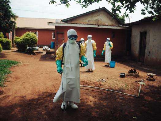 Medical staff wear PPE outside a clinic in DR Congo. 