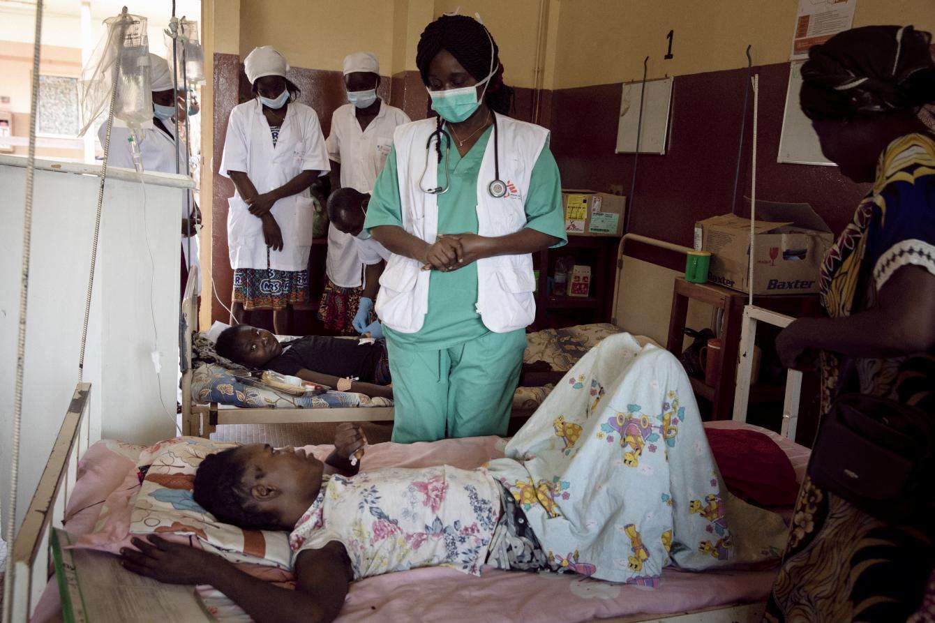 A doctor stands next to a patient in a hospital room in Bangui,Central African Republic.