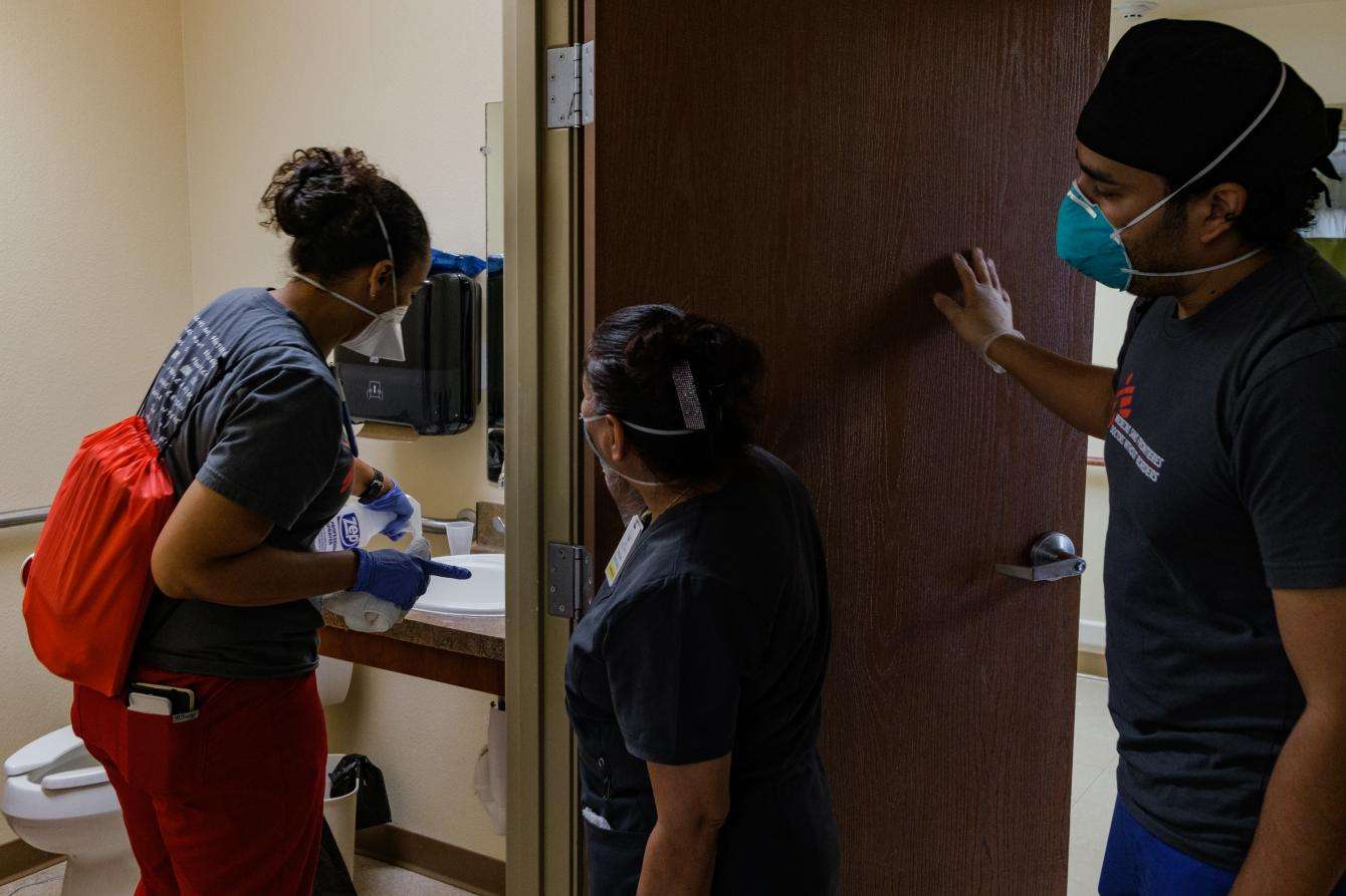 MSF's IPC nurse manager Kira Smith and MSF nurse Jonathan Garcia provide infection prevention and control guidance for an environmental services worker at Misty Willow Healthcare and Rehabilitation Center, a long-term care facility in Houston, Texas. 