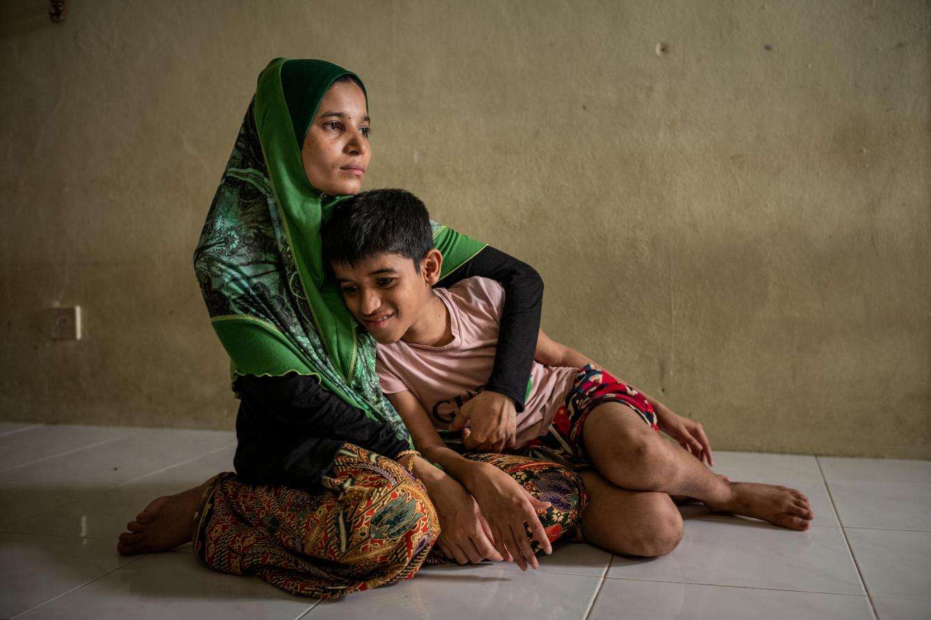 A Rohingya refugee in Malaysia comforts her child.