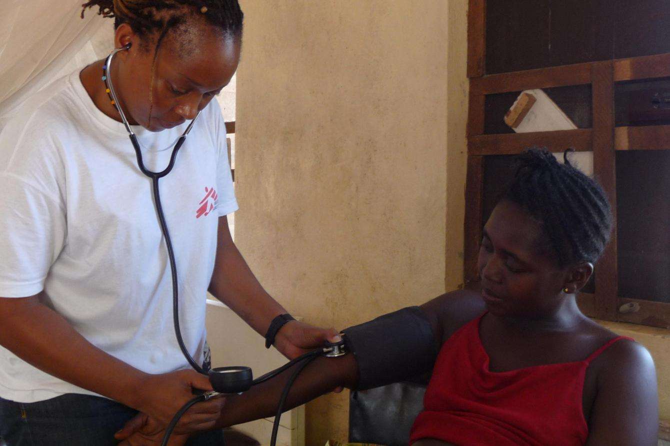 Kenyan midwife Rhoda Chemati examines Aminata Baimba