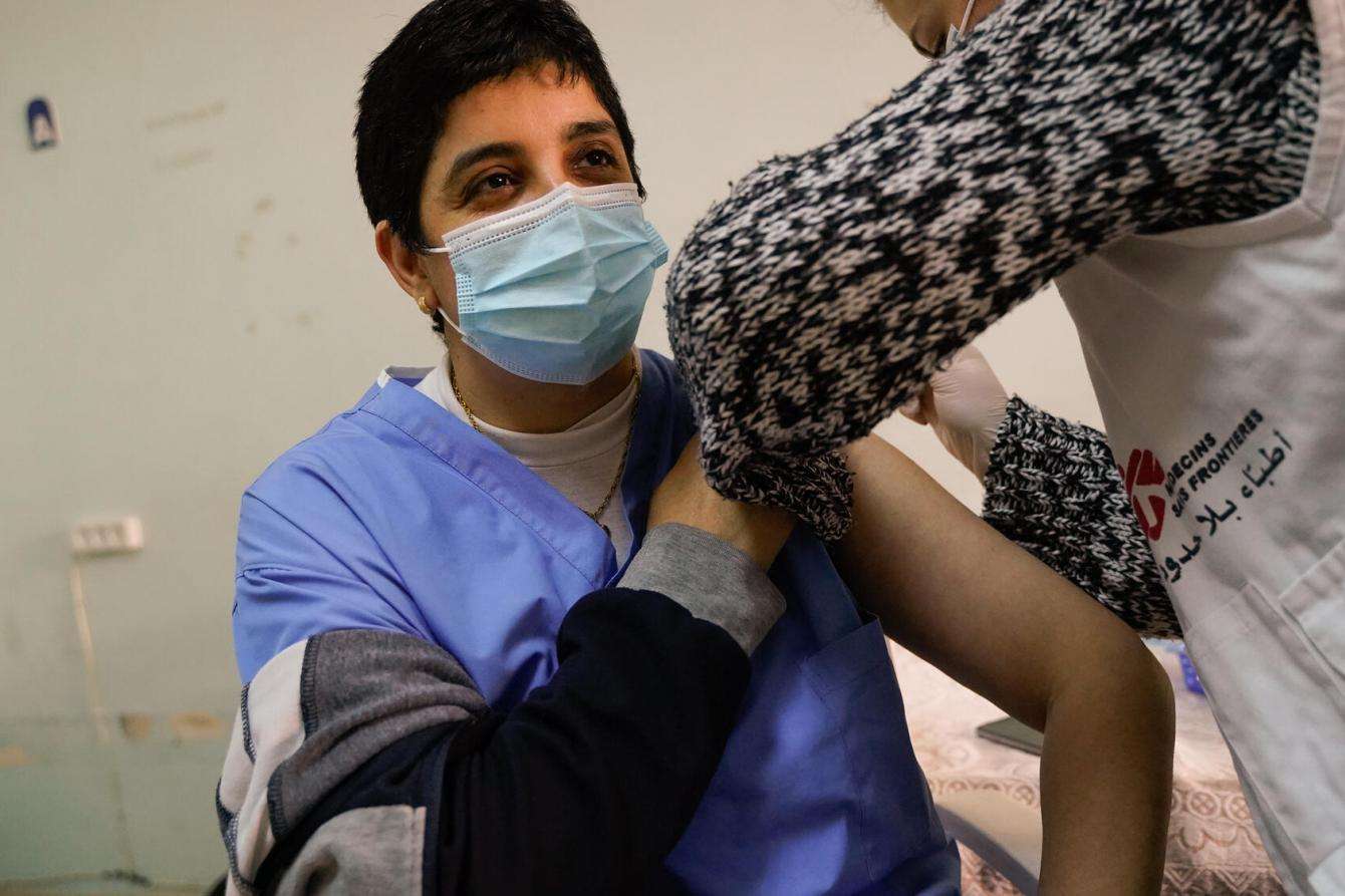 MSF medical mobile team member vaccinates a patient in northern Lebanese city of Tripoli.