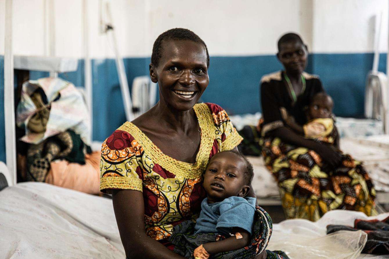 A woman holds her baby on a hospital bed in Ituri province, Democratic Republic of Congo. 