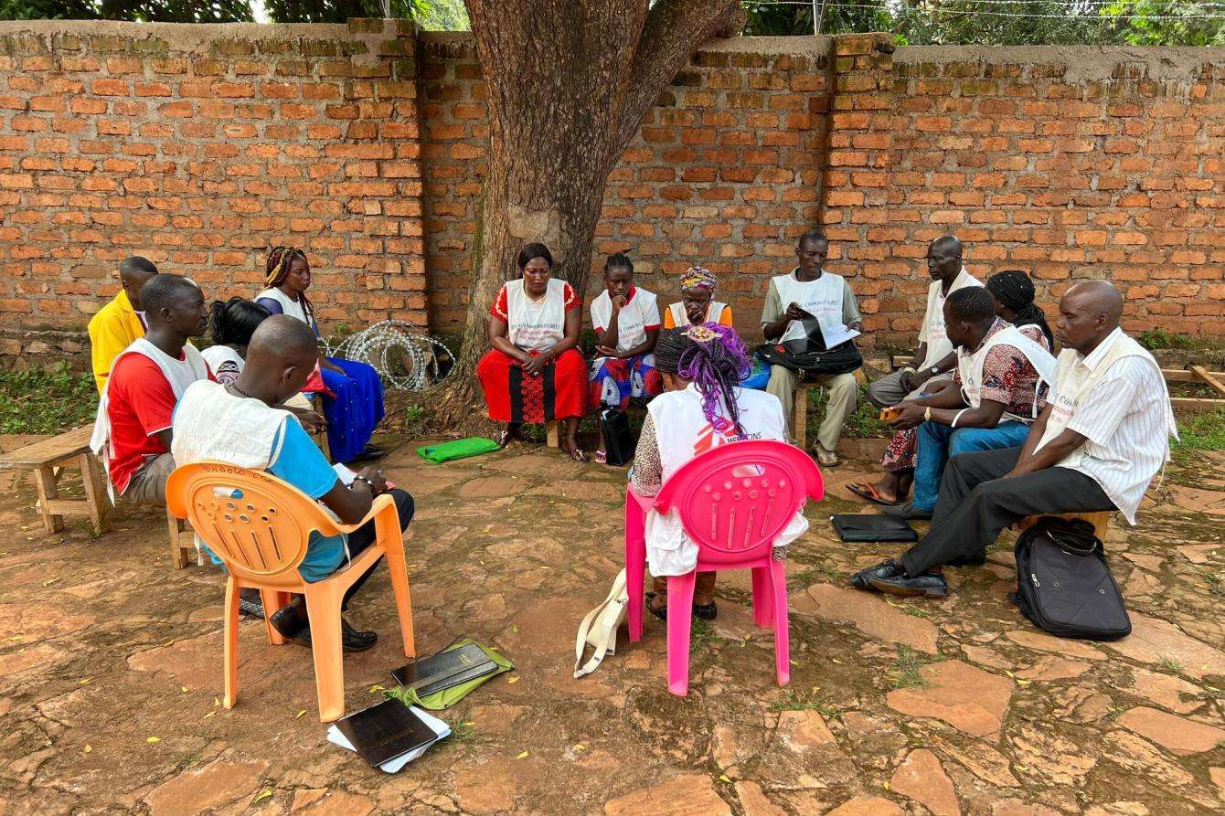Health care workers sit in a circle outside the Kidjigra center in Bambari, Central African Republic