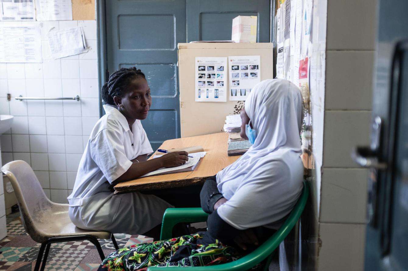 A midwife speaks with a patient at Chingussura health center in Beira, Mozambique.