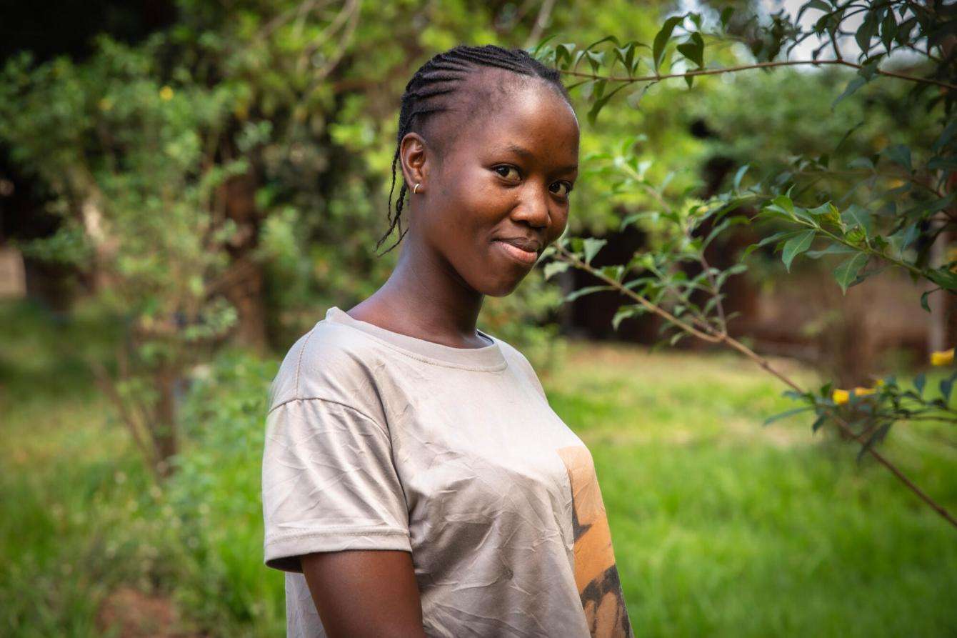 Young woman in a T-shirt standing in greenery in Central African Republic