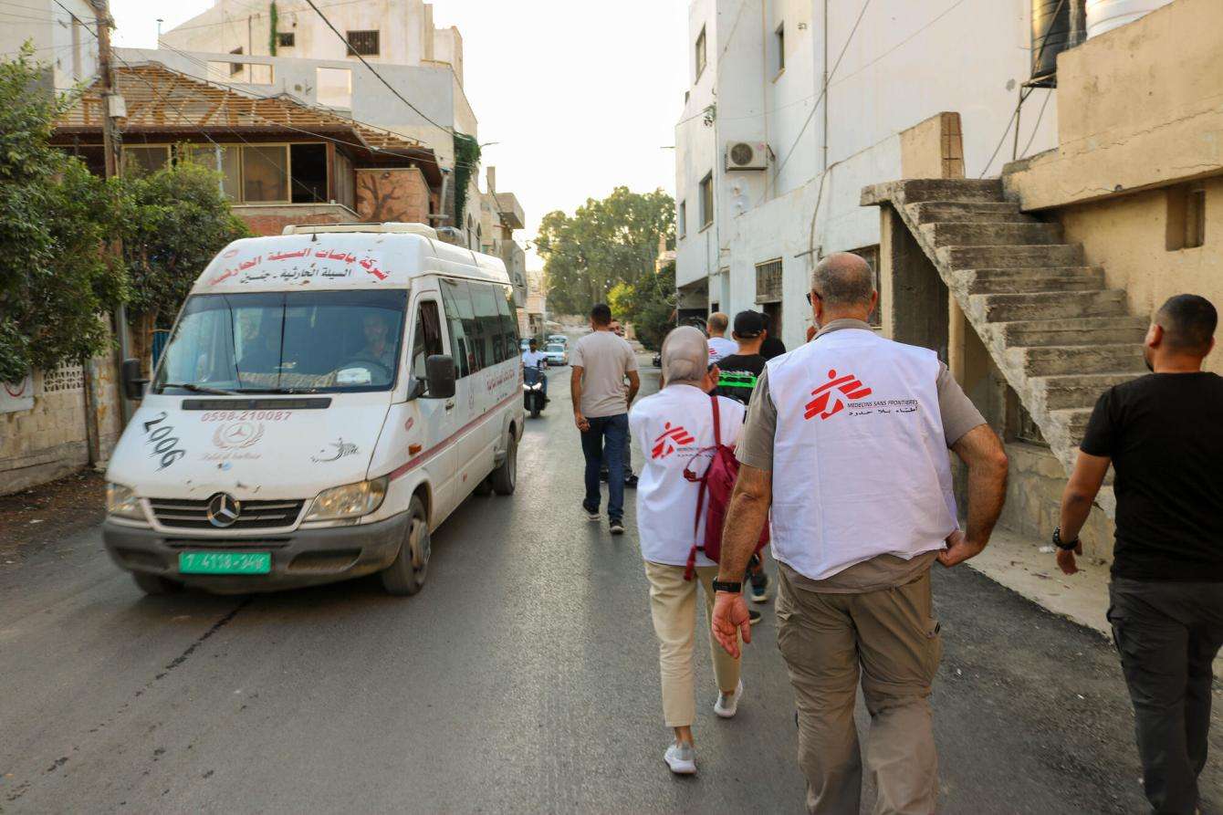MSF staff walk through a street in the West Bank while responding to an airstrike in Jenin.