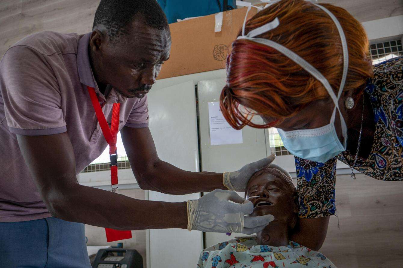 MSF Academy nursing student practices inserting a nasal catheter on a mannequin in South Sudan