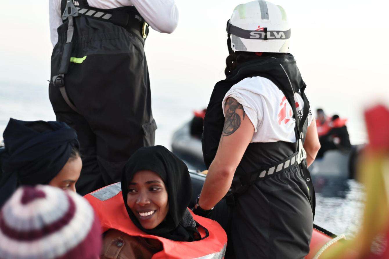 A smiling woman aboard an MSF rescue boat in the Mediterranean Sea.