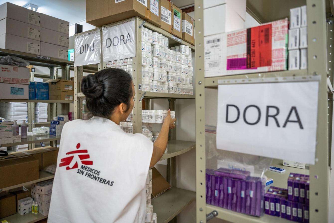 An MSF staff member stocks shelves with medication at a pharmacy in Honduras.