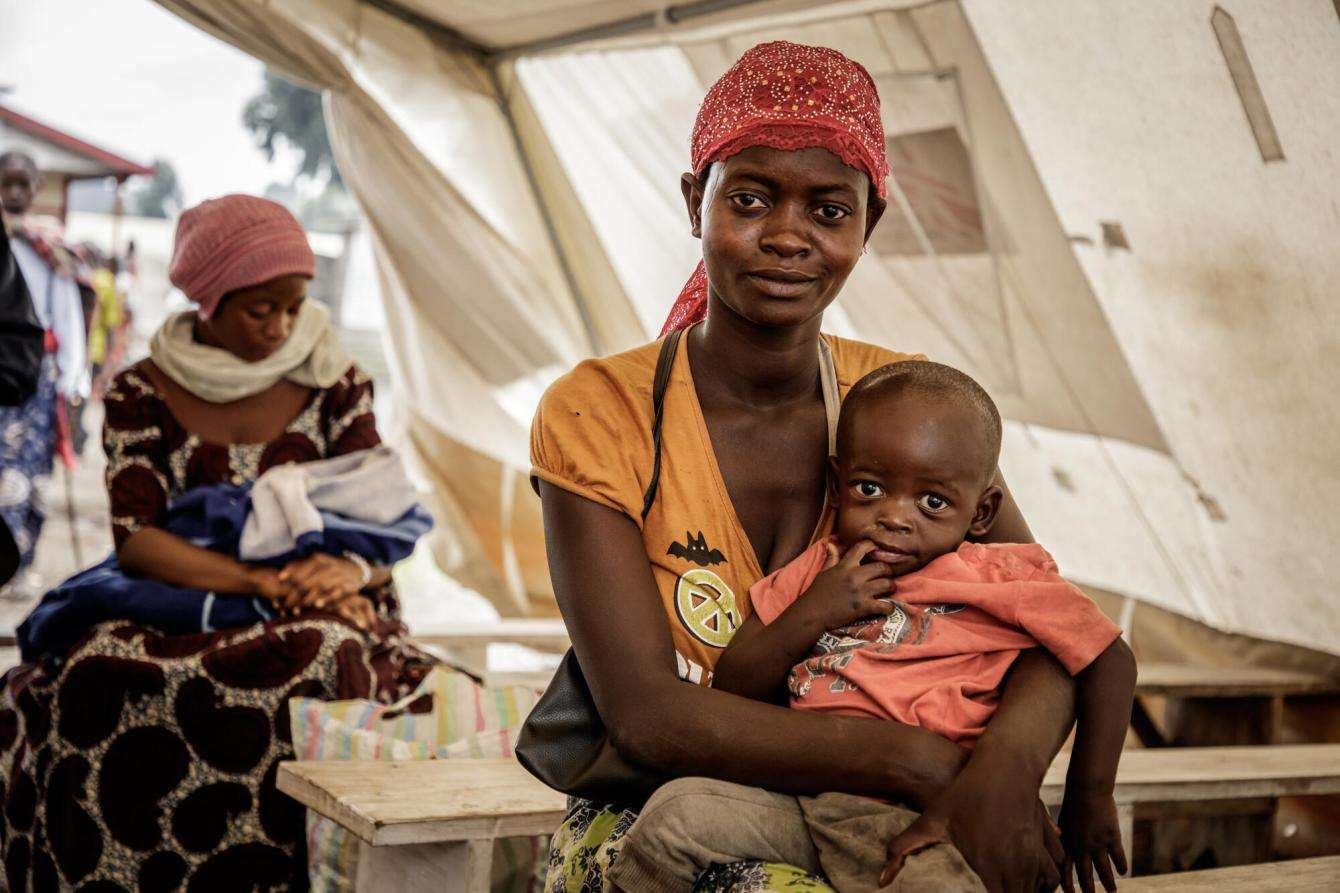 A displaced woman and her children at the Kanyaruchinya health center in Democratic Republic of Congo.