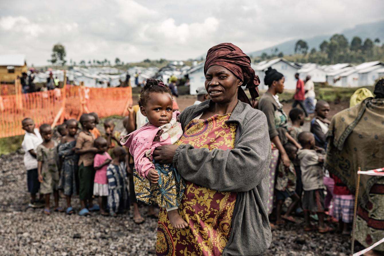 A woman holding a child at Kanyaruchinya displacement camp in Democratic Republic of Congo.