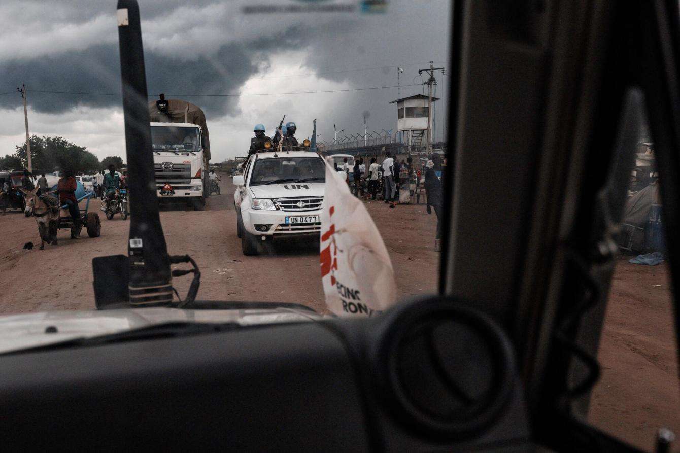 Storm clouds through a window showing an MSF vehicle in South Sudan.