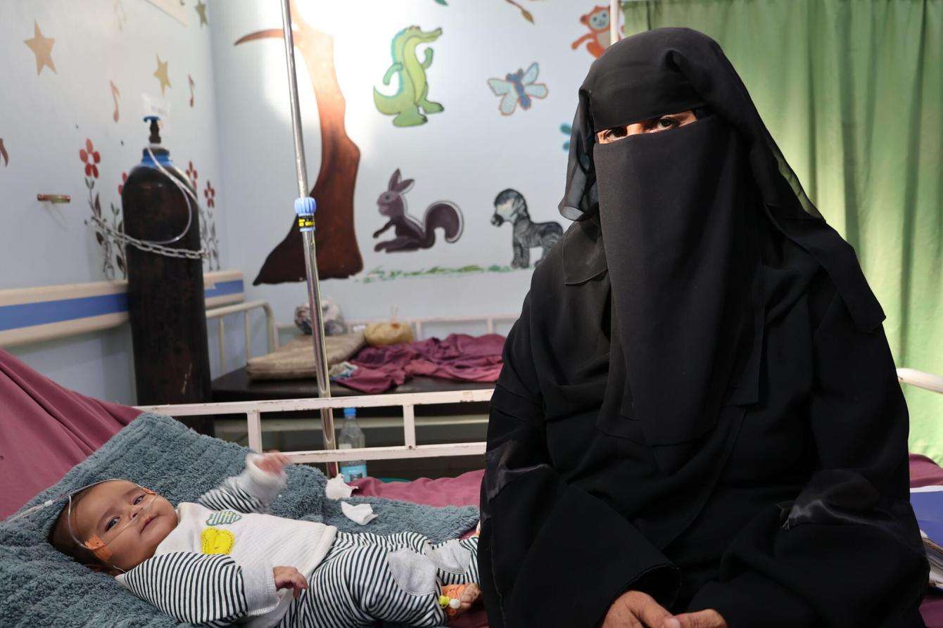 Salwa sits on her grandson’s hospital bed at MSF-supported Al-Qanawis Mother and Child Hospital in Al-Hudaydah governorate, Yemen.