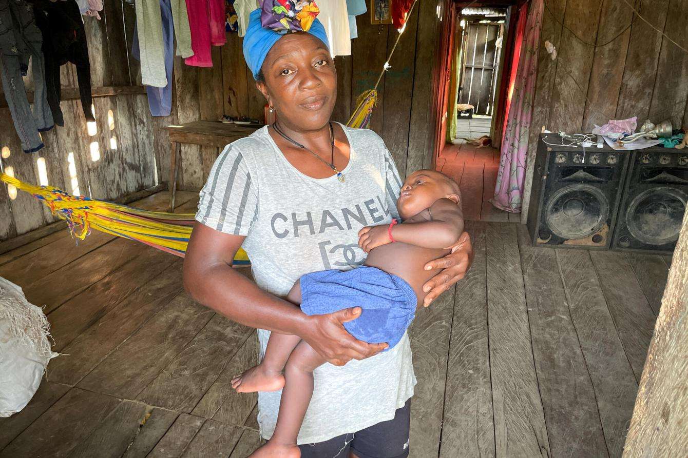 A mother holds her sleeping toddler in Colombia. 