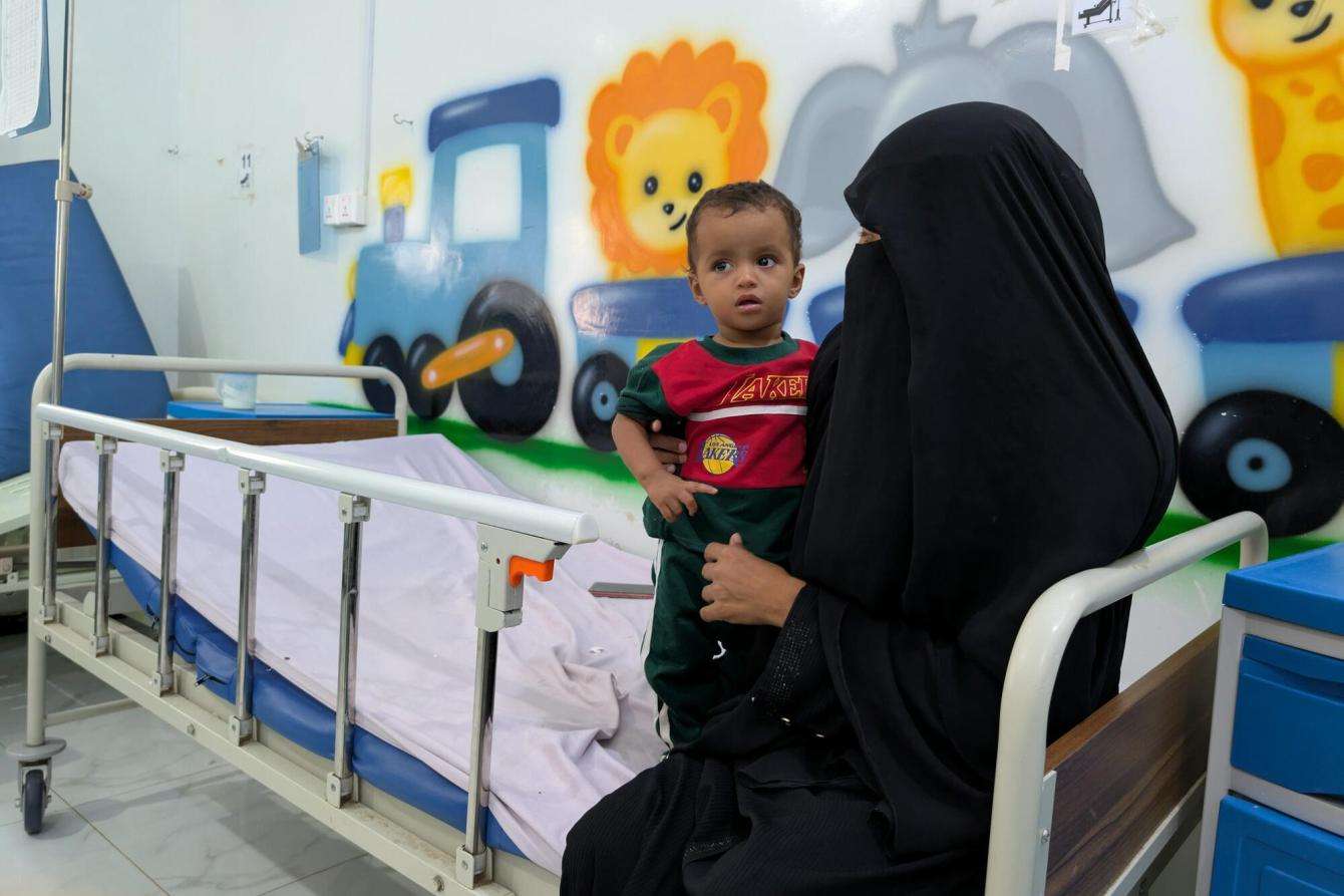 A woman holds her baby in a hospital in Yemen. 