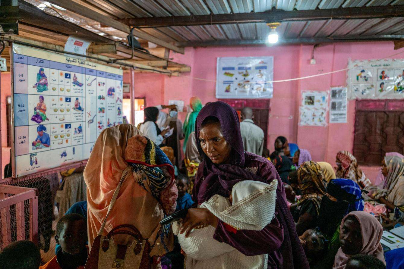 Families wait inside El Geneina Teaching Hospital, one of the few public hospitals still functioning in West Darfur, Sudan.