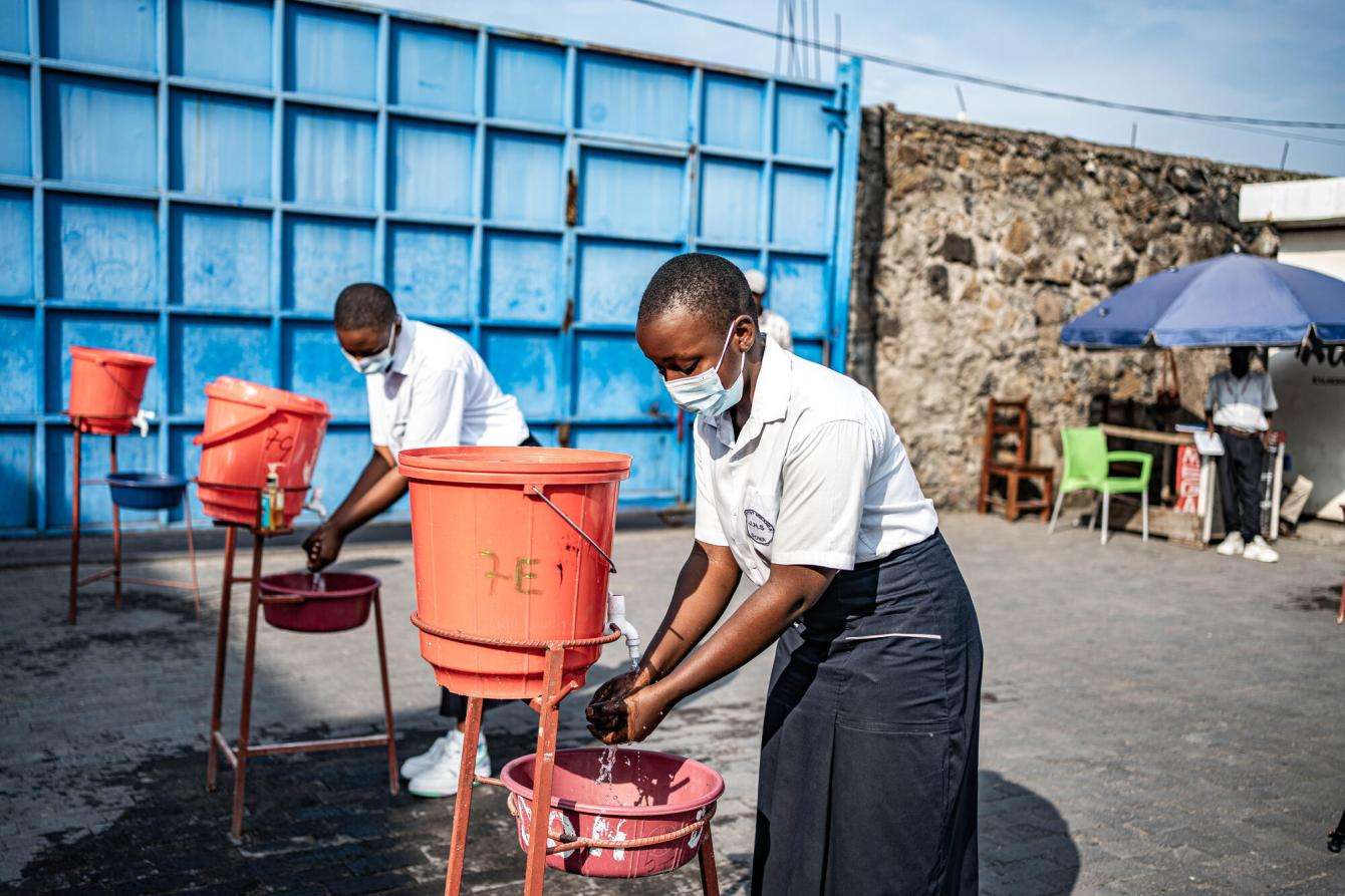 Students wash their hands before going to class at Mwanga College in Goma. Handwashing is a part of Ebola virus prevention measures.