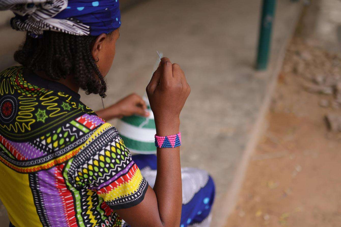 A woman sits with her back to camera in Nigeria. 