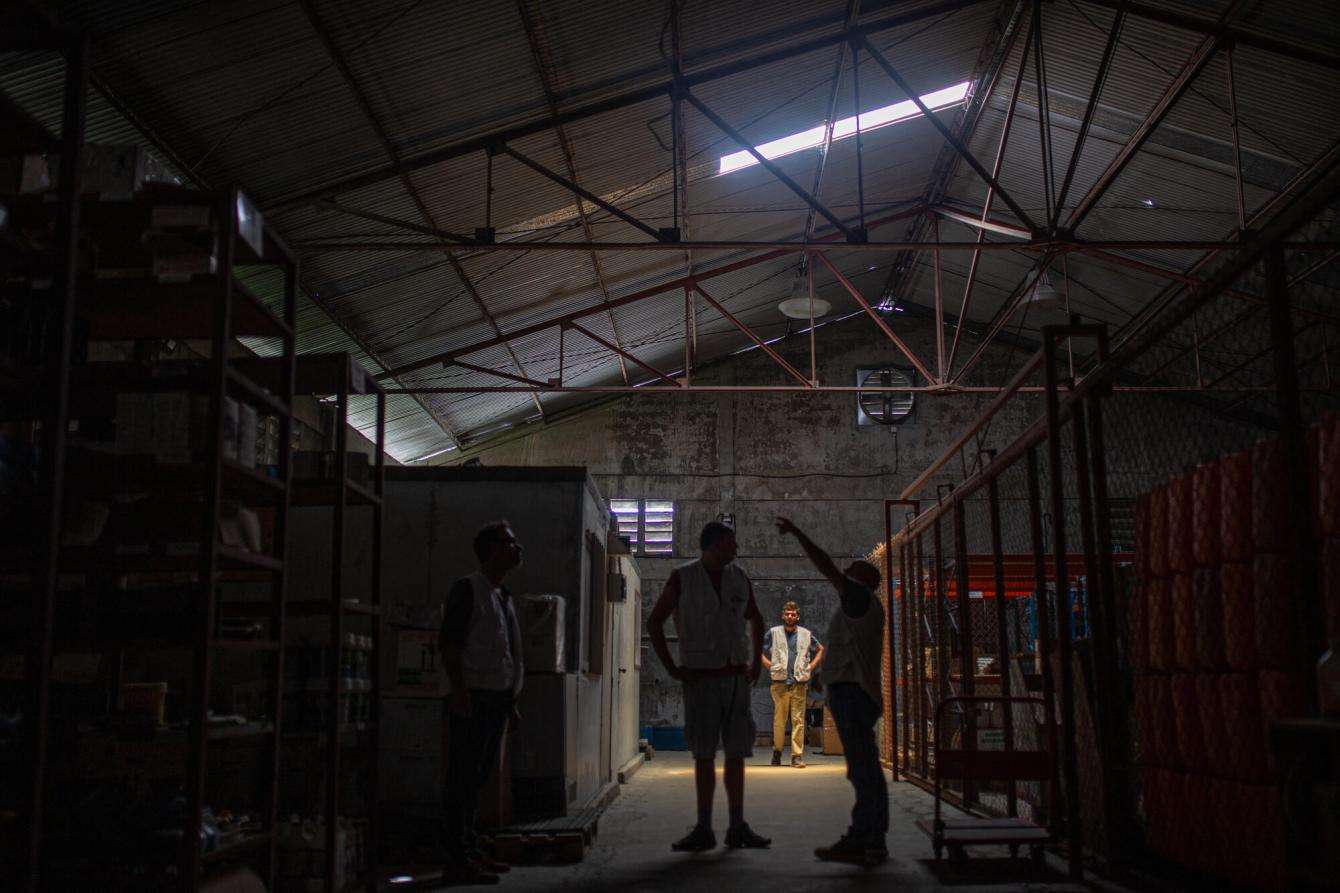 MSF's team assesses potential damage to the hospital in Cité Soleil, including bullet holes visible in the ceiling of the logistics stock area.
