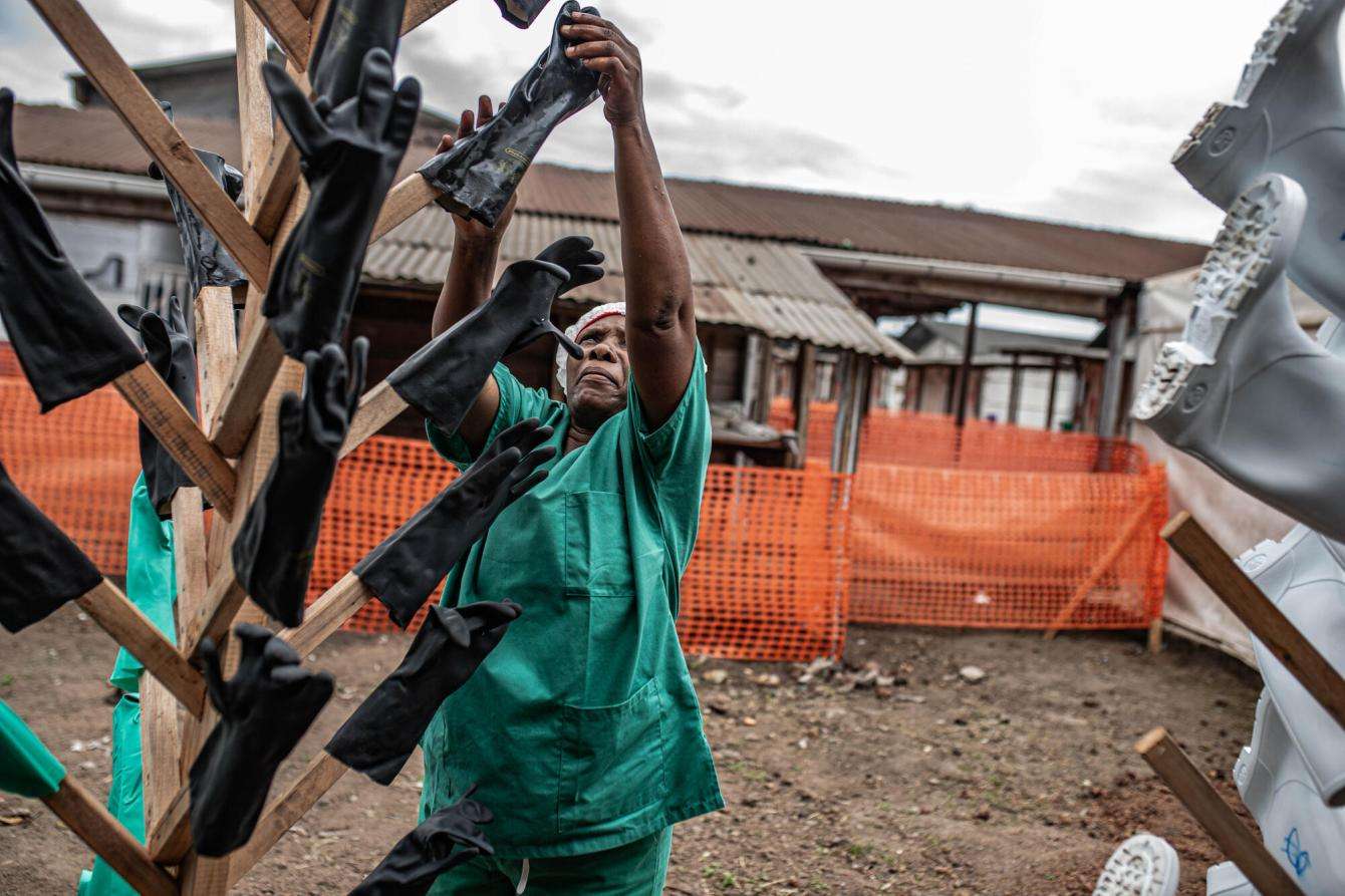 Teams disinfect equipment at MSF's Ebola treatment center in the Munigi site in Goma.