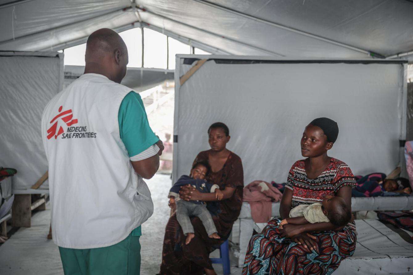 A nurse checks on patients at a cholera treatment center in DR Congo. 