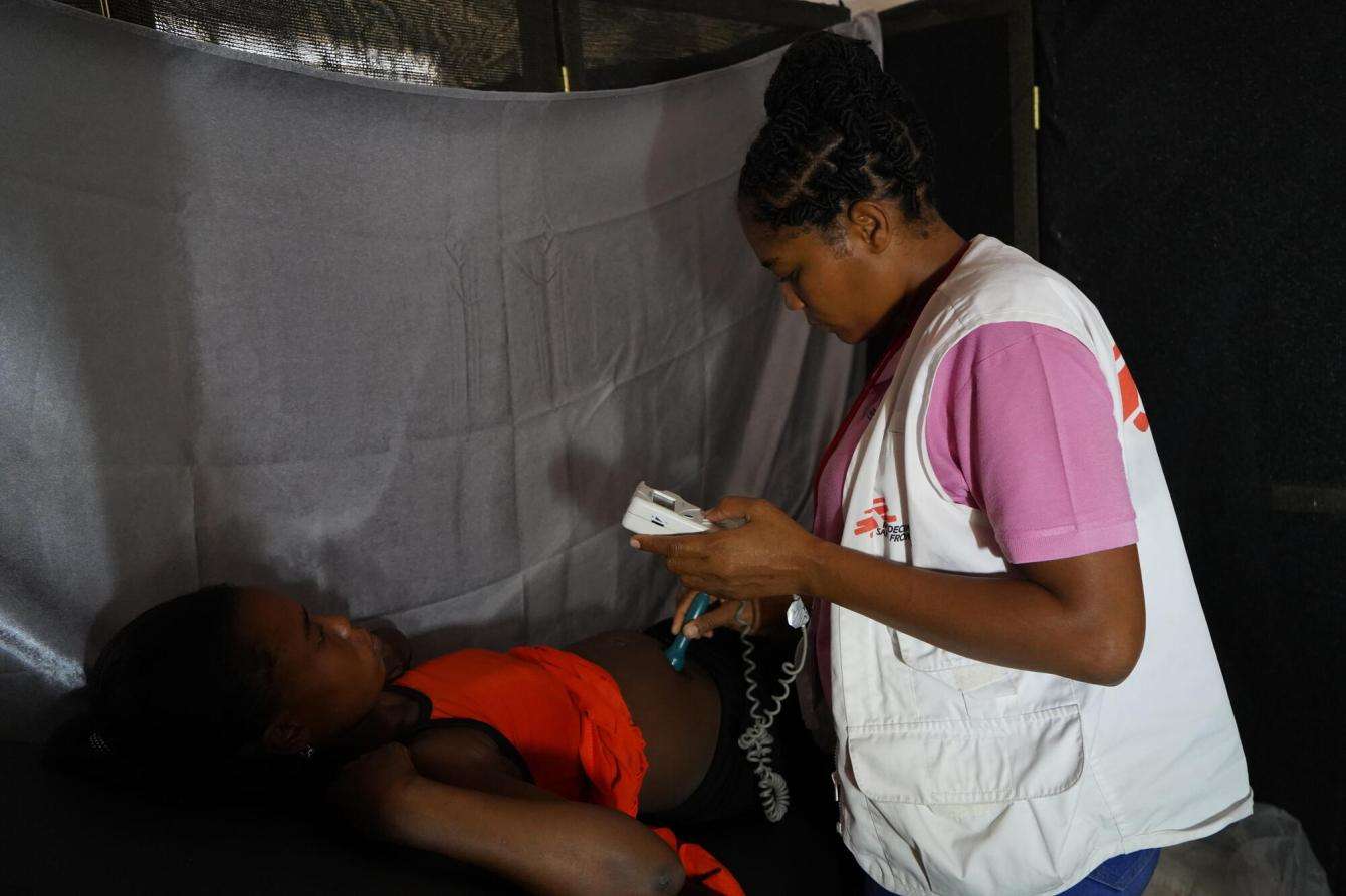 A nurse checks a pregnant patient in Haiti. 