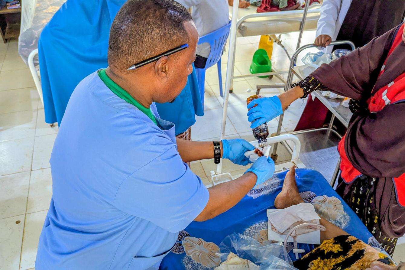 A doctor treats an injured leg in Somalia. 