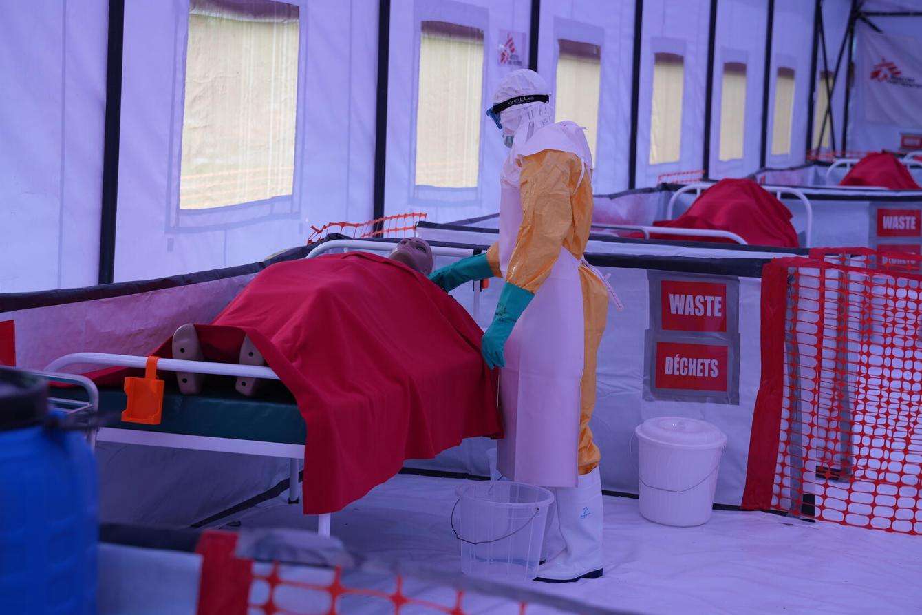 A health care worker trains with a patient mannequin inside MSF's Ebola simulation center in Kenya.